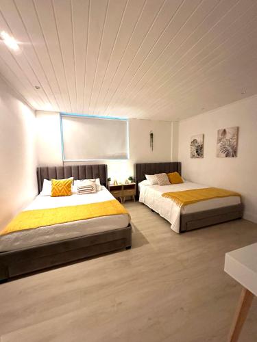 two beds in a large room with avertisement for at Amazing beachfront condo at Tides on Hollywood Beach Luxury Resort in Hollywood