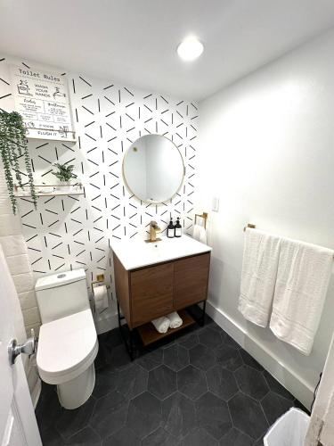 a bathroom with a toilet and a sink and a mirror at Amazing beachfront condo at Tides on Hollywood Beach Luxury Resort in Hollywood