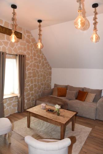 a living room with a couch and a table at Gîte des champs étoilés in Thuboeuf