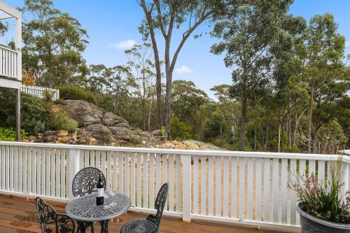 a patio with a table and chairs on a deck at Charming Studio in Braemar