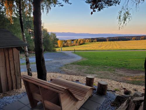 a bench sitting on a patio with a view of a field at Bewegung in Ruhe in Bachones