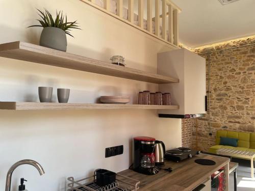 a kitchen with a counter top with a coffee maker at Sphnix Apartments B in Chios