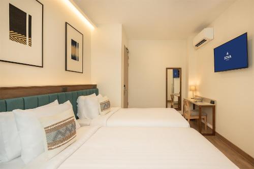 Ένα ή περισσότερα κρεβάτια σε δωμάτιο στο SOVA Hotel Bangkok