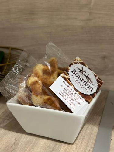 a package of donuts in a box on a table at Studio d'Hôtes Victoire in Sainghin-en-Weppes