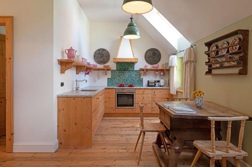a kitchen with a wooden table and a stove at Altaussee Retreat Apartment - Your Austrian Home in Altaussee