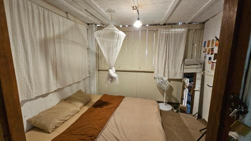 a small bedroom with a bed in a room at Panakluea at Kokuang Homestay in Ban Na Lae