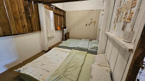 an empty room with two beds in it at Panakluea at Kokuang Homestay in Ban Na Lae