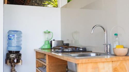 a kitchen with a sink and a counter top at Anda Amed Villas & Spa in Amed