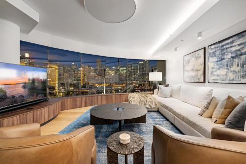 a living room with a couch and a table at 3 Bedroom Darling Harbour Apartment in Sydney