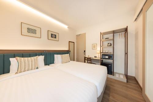 Ένα ή περισσότερα κρεβάτια σε δωμάτιο στο SOVA Hotel Bangkok