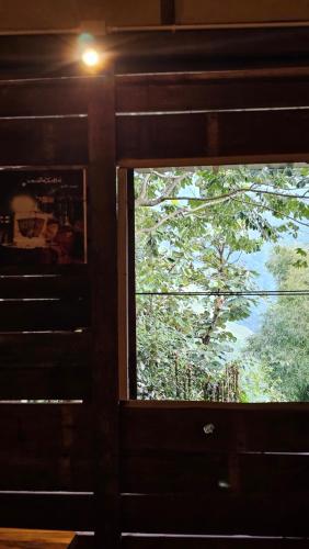 a window in a room with a view of a tree at Panakluea at Kokuang Homestay in Ban Na Lae