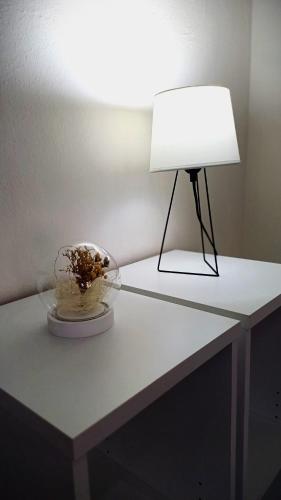 a table with a lamp and a bowl on it at Apartmán Marty in Nové Zámky