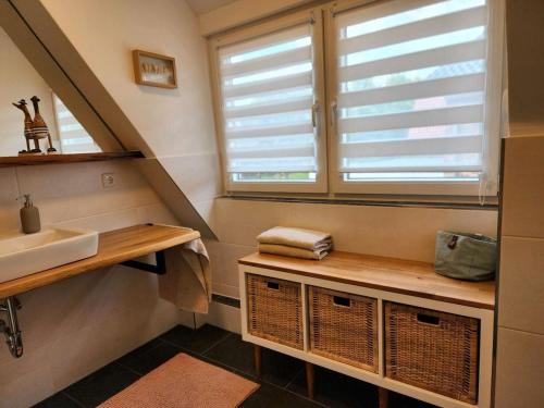 a bathroom with a sink and a window at Lütt Bliev - Fewo in Stade in Stade