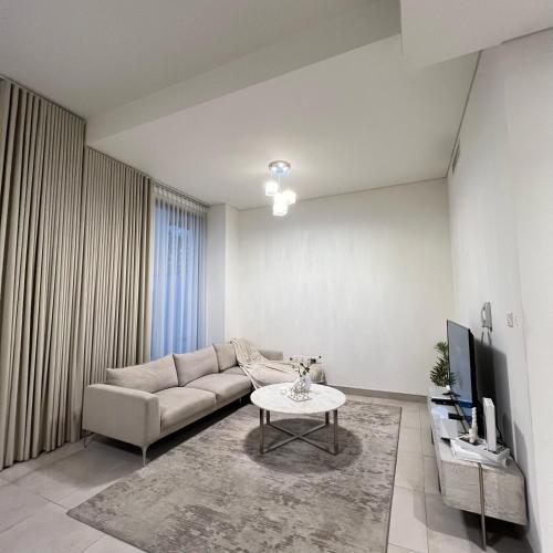 a living room with a couch and a table at Dream Holiday Home Private Pool in Ras al Khaimah