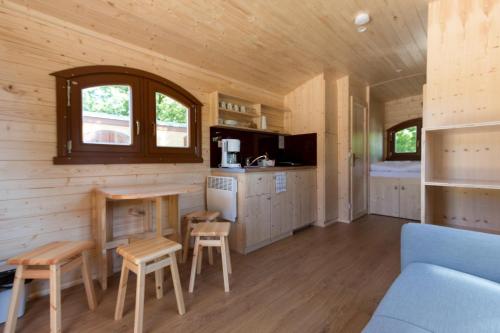 a kitchen and living room of a tiny house at Vier Jahreszeiten Camping - Biggesee in Olpe