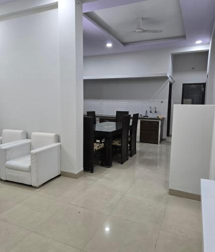 a living room with a dining room table and chairs at Satyabhama Home Stay - Opel - Two BHK in Indore
