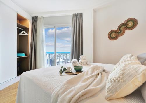 a bedroom with a bed with a view of the ocean at Silvic Jable in Corralejo