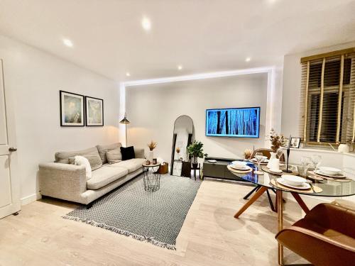 a living room with a couch and a table at Superb Duplex in Hendon in The Hyde