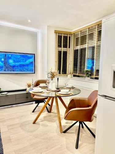 a living room with a dining room table and chairs at Superb Duplex in Hendon in The Hyde