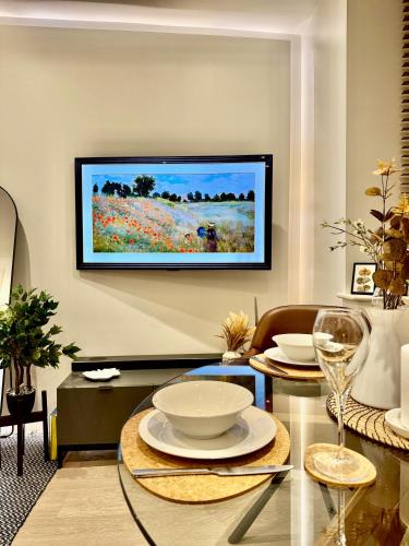 a living room with a tv hanging on the wall at Superb Duplex in Hendon in The Hyde