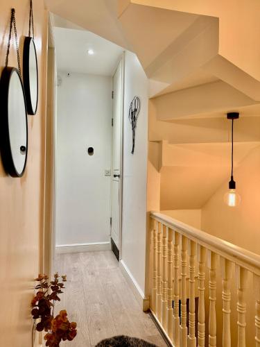 a staircase in a house with white walls and ceilings at Superb Duplex in Hendon in The Hyde