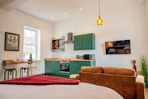 a living room with a couch and a table at WhiskAwayStays Foregate Studio no 6 in Worcester