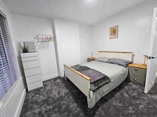 a bedroom with a bed and a basketball hoop at Newly Renovated 2 Bed with Garden & Parking in Ipswich