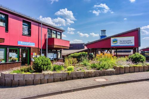 a group of buildings with plants in front of them at Vier Jahreszeiten Camping - Biggesee in Olpe