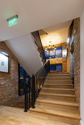 a staircase in a building with a brick wall at Reea Boutique Hotel in Târgovişte