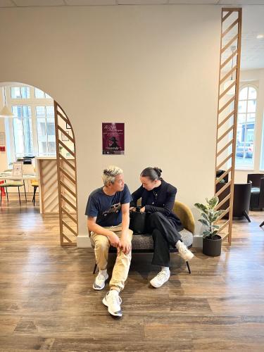 two people sitting on a couch in a room at Hotel Balmoral Dinard in Dinard