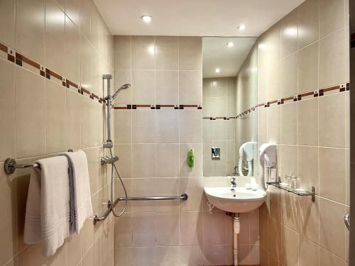 a bathroom with a sink and a shower at Hotel Balmoral Dinard in Dinard