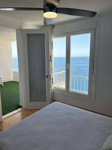 a bedroom with a bed with a view of the ocean at De la Montaña al Mar in Almería