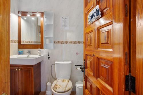a bathroom with a toilet and a sink at Los Secretos De San Marcos Seaview in San Marcos