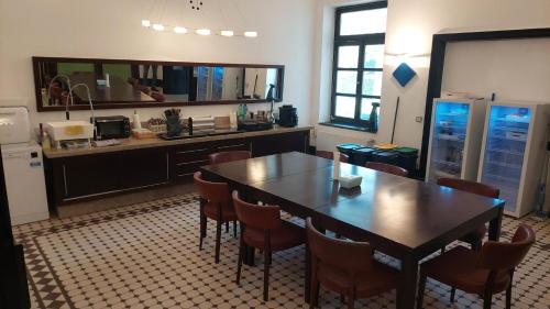 a kitchen with a table and chairs and a counter at die Villa, Zimmer 22, DZ in Leverkusen