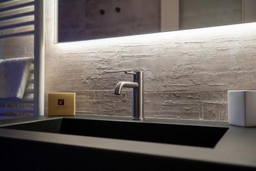 a sink with a faucet in a bathroom at I Tre Poggi Dimora di Charme in Canelli