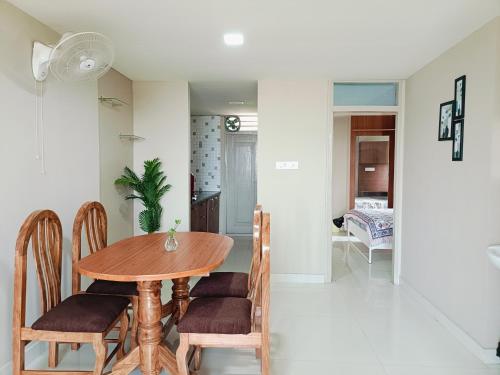 a dining room with a wooden table and chairs at 2BHK Flat by SR Renton Comfort Homestay Mysore @ Vijayanagar 2nd stage Mysore in Mysore