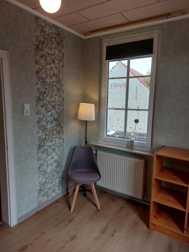 a room with a chair and a window at Ferienwohnung am Drömling Südheide - Kurt in Bergfeld