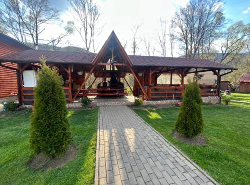 a log cabin with a walkway in front of it at Cabana Sweetlife in Rimetea