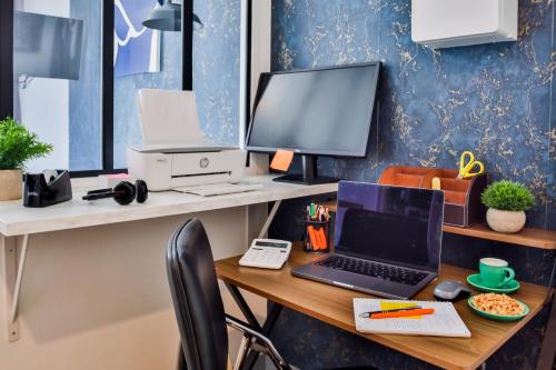 un bureau avec un bureau, un ordinateur portable et un moniteur dans l'établissement WS Opéra - Rossini, à Paris