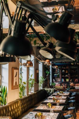 a row of tables in a restaurant with lights at Gorgeous George by Design Hotels ™ in Cape Town