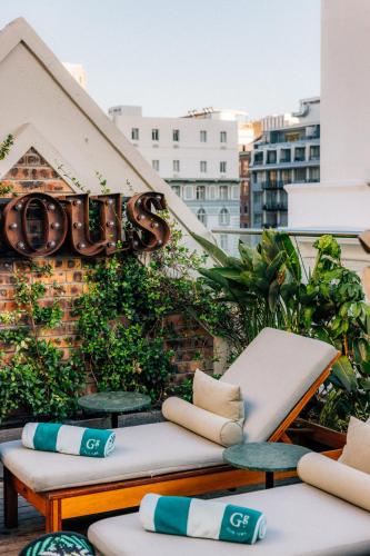 a balcony with two benches and a sign on a building at Gorgeous George by Design Hotels ™ in Cape Town