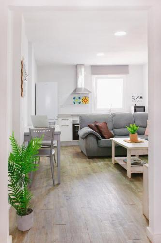 a living room with a couch and a table at APARTAMENTO LOS LANCES PLAYA in Tarifa