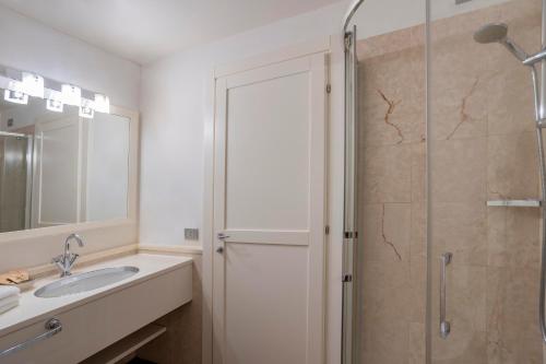 a bathroom with a sink and a shower at Resort Antico Verbano in Meina