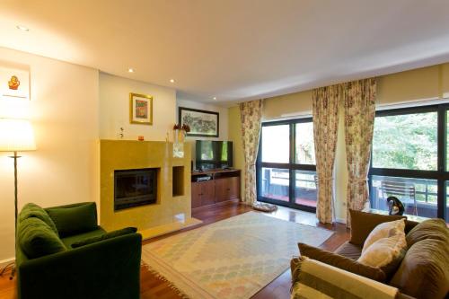 a living room with a couch and a fireplace at VIVA Belos Ares in Porto