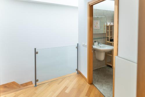 a bathroom with a toilet and a sink at NEST LIVING Sunset 42 in Udine