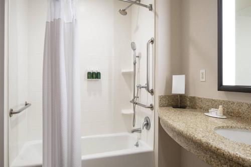 a bathroom with a shower and a sink and a tub at Courtyard by Marriott Santa Barbara Goleta in Santa Barbara