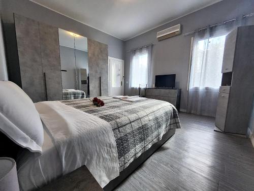 a bedroom with a large bed and a large mirror at Alloggio M&M in Padova