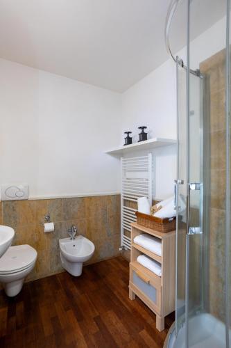 a bathroom with a toilet and a sink and a shower at Resort Antico Verbano in Meina