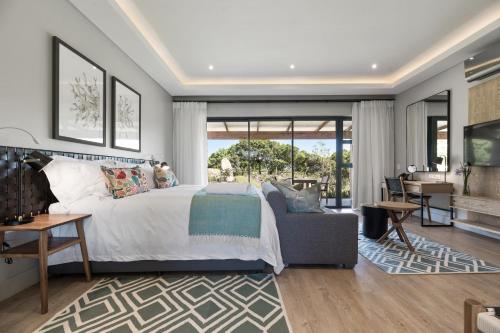 a bedroom with a bed and a living room at Hotel Olivewood in East London