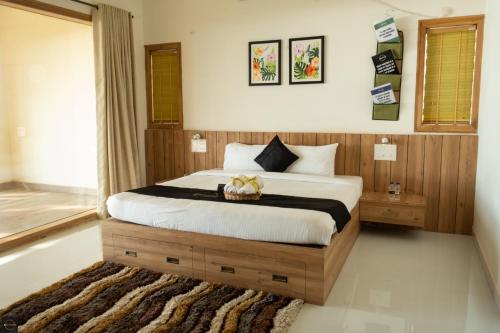 a bedroom with a large bed with a basket on it at Reunion Ocean Elite - Beach House in Udupi